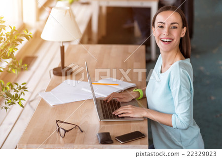 Nice woman sitting at the table 22329023