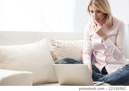 Attractive young woman is resting at home 22330362