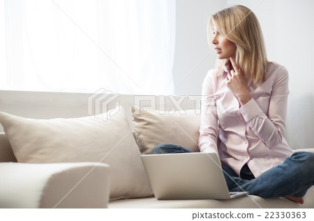 Cute blond girl is using a notebook 22330363