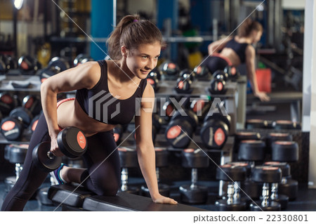 Woman with barbell at the gym 22330801