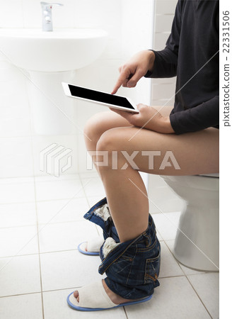 young man in toilet using tablet 22331506