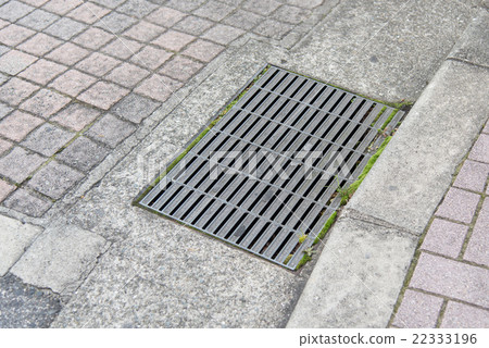 sewer manhole cover in a city street 22333196