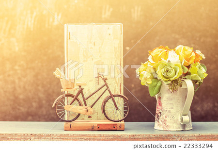 Bicycle and flowers on a wooden Bicycle and flowers on a wooden 22333294
