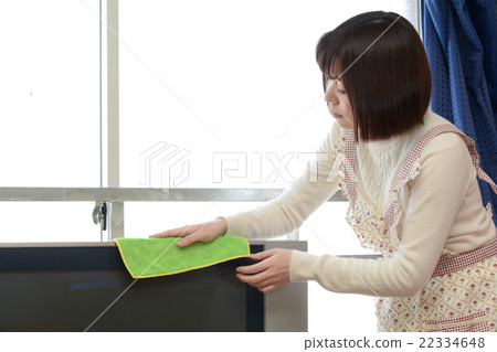 Woman wiping TV 22334648