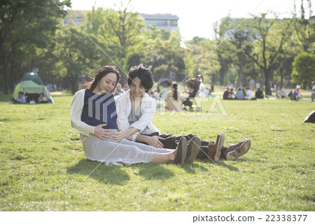 A couple sitting on the lawn A couple sitting on the lawn 22338377