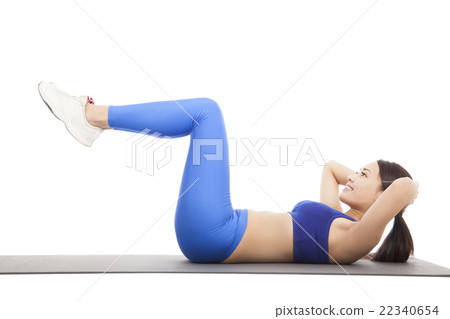 Fit blonde doing pilates core exercise in studio 22340654