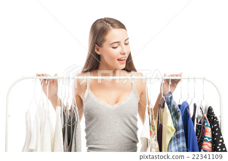 Excited brunette looking down at clothes 22341109