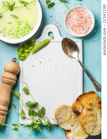 Light summer green pea cream soup in bowl with Light summer green pea cream soup in bowl with 22341199