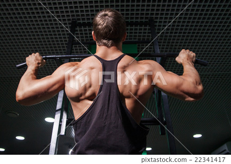 Strong muscular man doing pull ups on bar Strong muscular man doing pull ups on bar 22341417