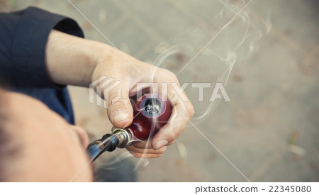 Man smoking pipe, photo with selective focus Man smoking pipe, photo with selective focus 22345080