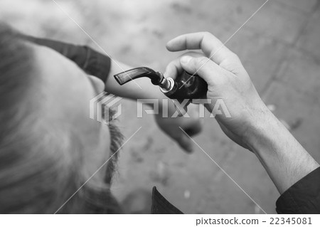 Man smoks pipe, black and white outdoor photo 22345081