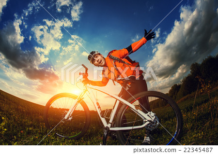 Man Cyclist with bike on sunset 22345487