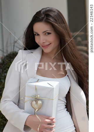 The beautiful young girl with a gift The beautiful young girl with a gift 22346143