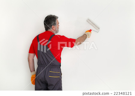 Worker paint wall in a room 22348121