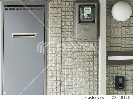 Around the entrance of a house facility apartment and an embedded water heater 22348338