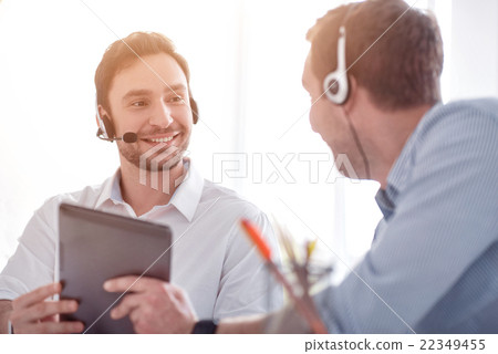 Pleasant colleagues sitting at the table Pleasant colleagues sitting at the table 22349455