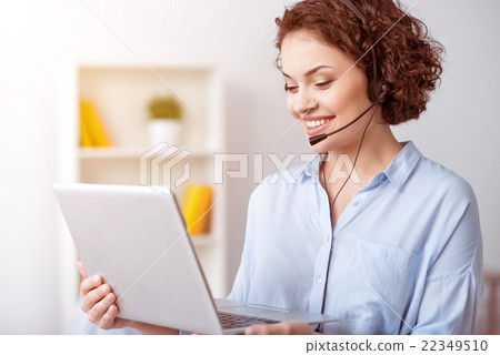 Cheerful woman holding laptop Cheerful woman holding laptop 22349510