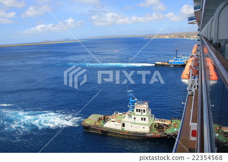 A boat pushing a large passenger ship 22354568