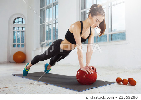 Stock Photo: Beautiful slim brunette doing some gymnastics at