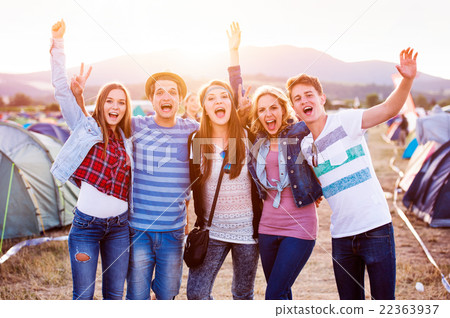 Group of teenagers at summer music festival, sunny Group of teenagers at summer music festival, sunny 22363937
