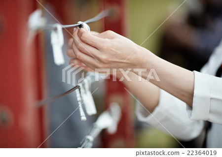 A woman holding an Omikuji 22364019