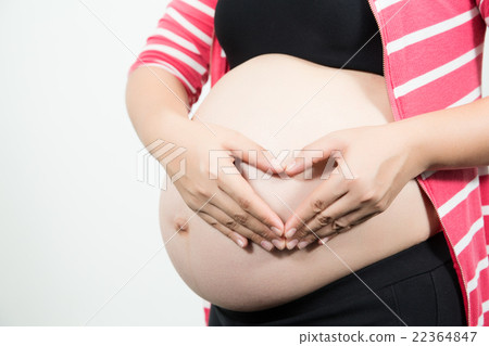 beautiful 9 month pregnant woman with heart from hands. 22364847