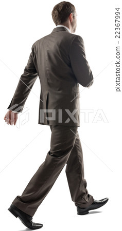 Young businessman with short dark hair walking  22367994