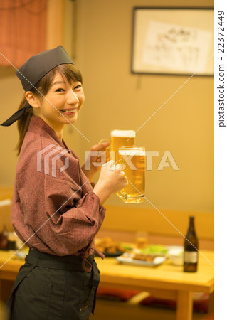 Woman clerk carrying draft beer 22372449