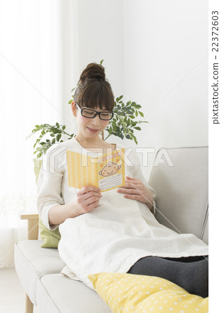 Pregnant woman watching maternal and child handbook 22372603