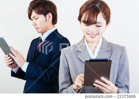 Business men and women using tablets Business men and women using tablets 22375686