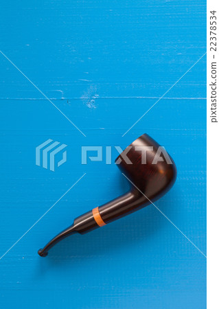Luxury tobacco pipe on the blue table 22378534
