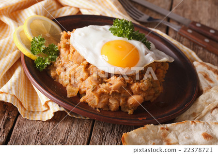 ful medames with a fried egg and pita close up ful medames with a fried egg and pita close up 22378721
