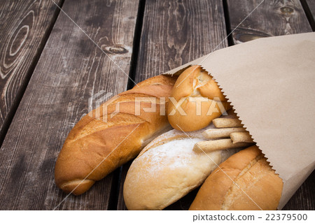 Bread in a paper bag. Loaf on a wooden table. Bake 22379500