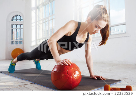 Beautiful slim brunette doing some gymnastics at 22383529