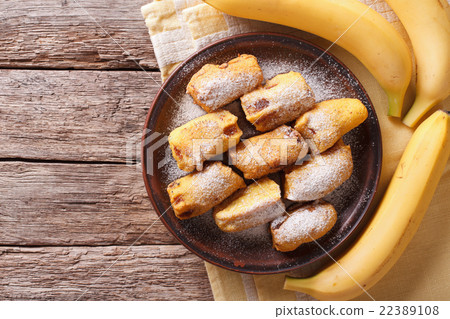 Fried bananas in batter on a plate. top view 22389108