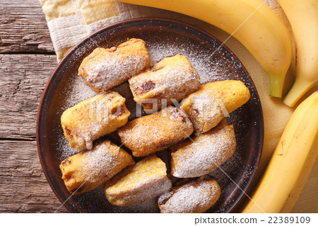 Fried bananas in batter on a plate closeup 22389109