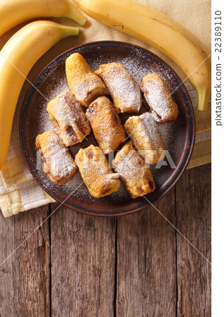 Fried bananas in batter on a plate Fried bananas in batter on a plate 22389110