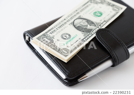 A notebook and dollar 22390231