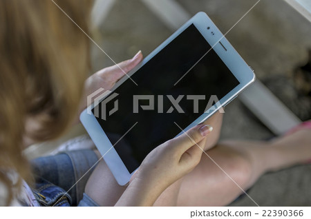 Girl holding a blank tablet Girl holding a blank tablet 22390366