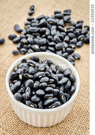 Black bean seeds in white cup. Black bean seeds in white cup. 22393010