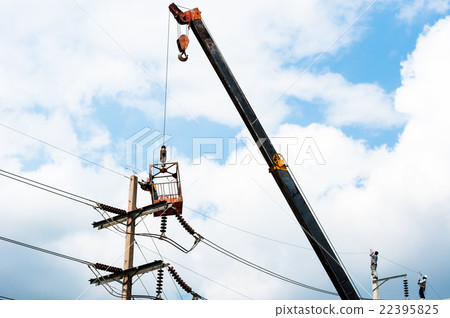 technician works in bucket high up on a power pole technician works in bucket high up on a power pole 22395825