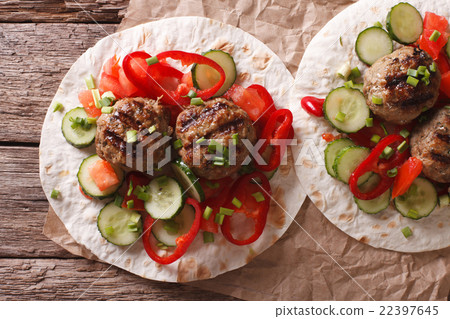Grilled meat balls with vegetables on a flat bread Grilled meat balls with vegetables on a flat bread 22397645