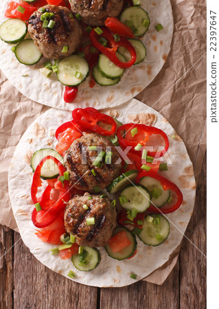 Grilled meat balls with vegetables on a flat bread 22397647