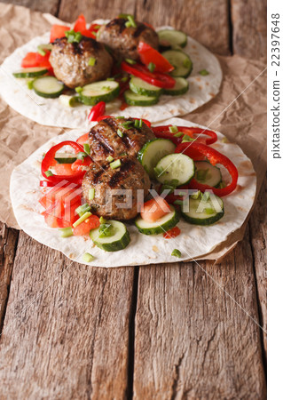 Grilled meat balls with vegetables on a flat bread 22397648
