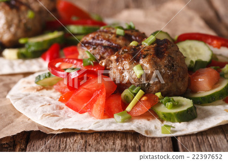 Turkish kofta with fresh vegetables on flat bread 22397652