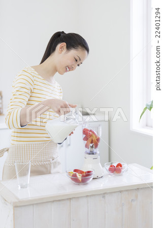 A Japanese woman standing in the kitchen 22401294