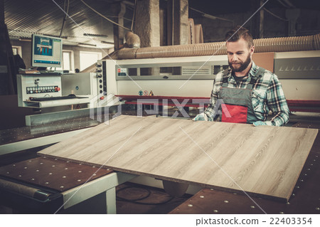 Carpenter doing his job in carpentry workshop. 22403354