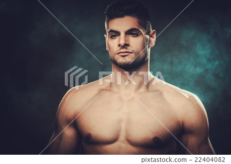 Hispanic man with naked torso posing in studio. 22404082