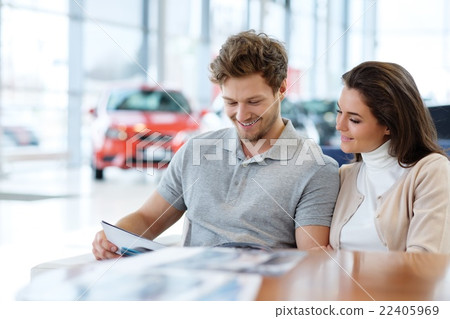 Young couple at the dealership showroom. 22405969