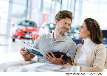 Young couple at the dealership showroom. Young couple at the dealership showroom. 22405970